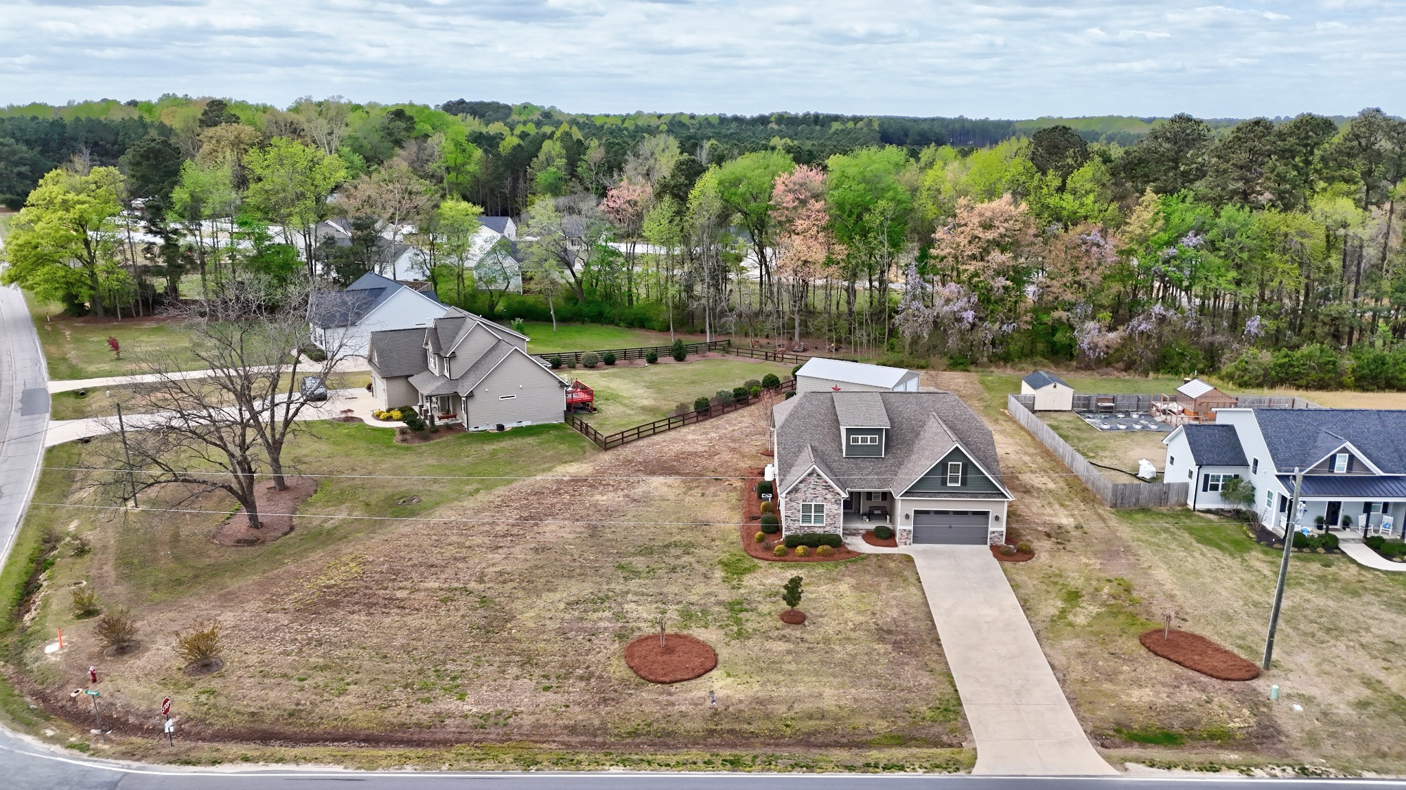 Aerial drone photograph showing a home, lot, and neighborhood context